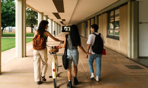 a group of people walking down a sidewalk