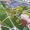 aerial view of a campus with a lot of green space and buildings