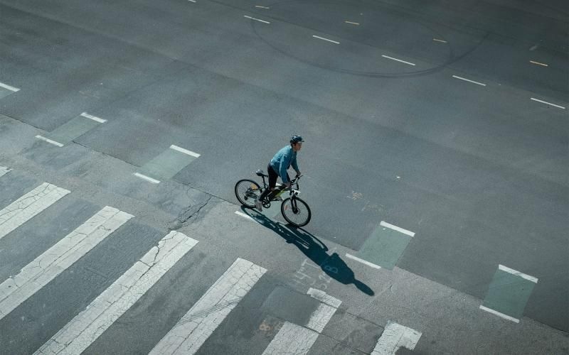 a person riding a bicycle on a street