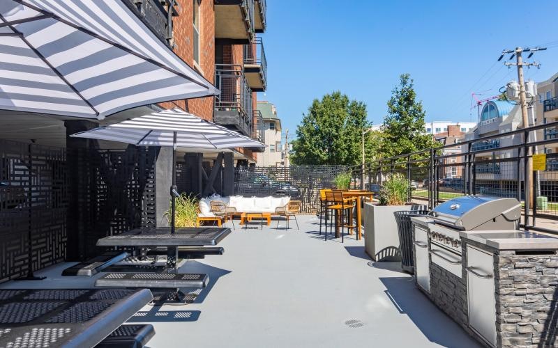 a courtyard with tables and umbrellas