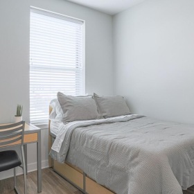 Relax and recharge at Lancaster Apartments a bed in a room