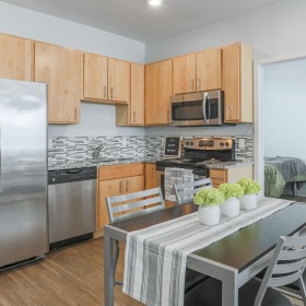 Spacious kitchens with thoughtful details a kitchen with a table and chairs