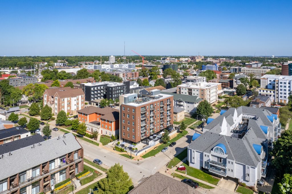 Aerial photo of the Lancaster apartments building showing surrounding neighborhood with horizon and sky visible.